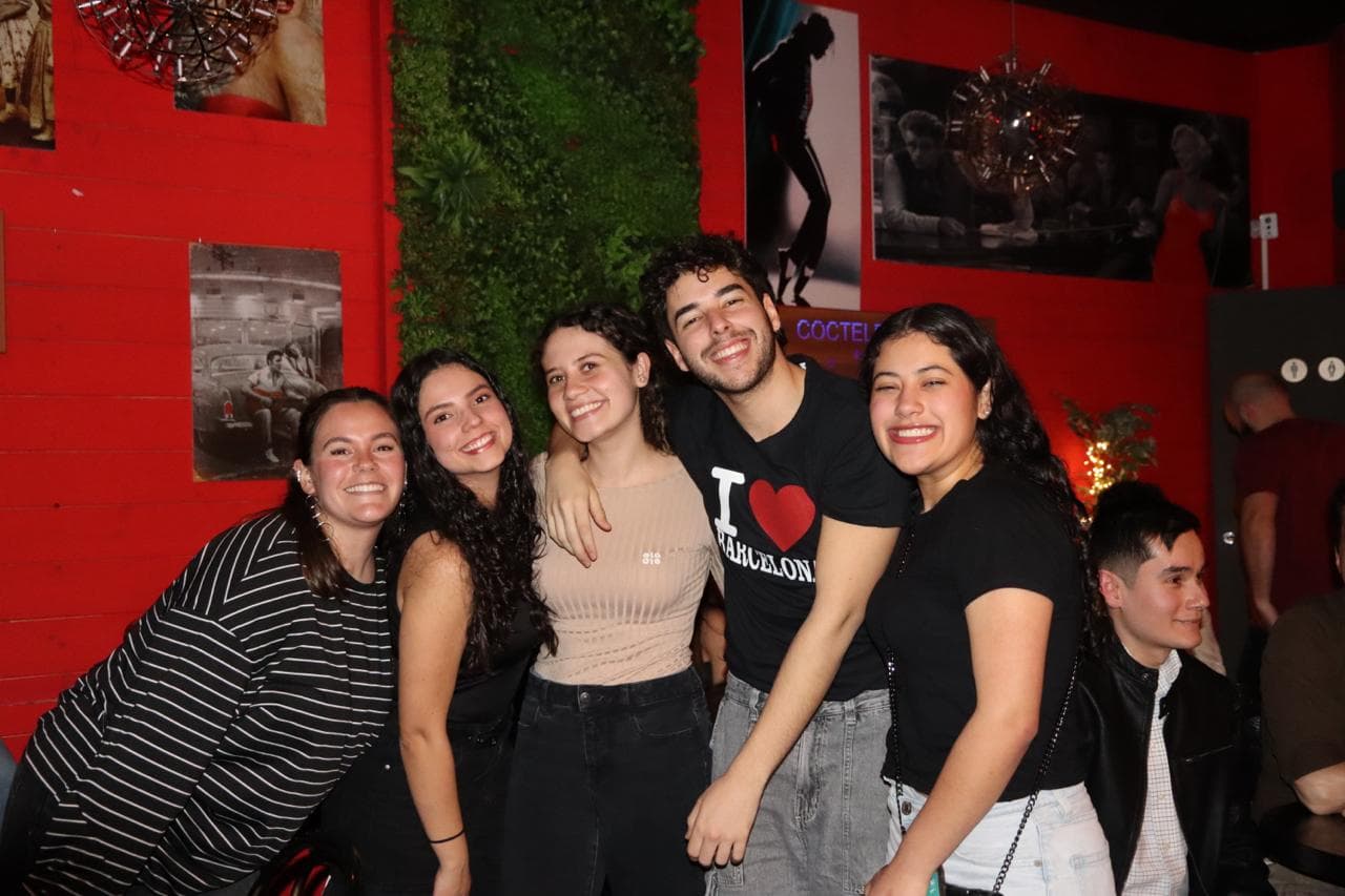 A smiling group posing together at a Barcelona International Social event